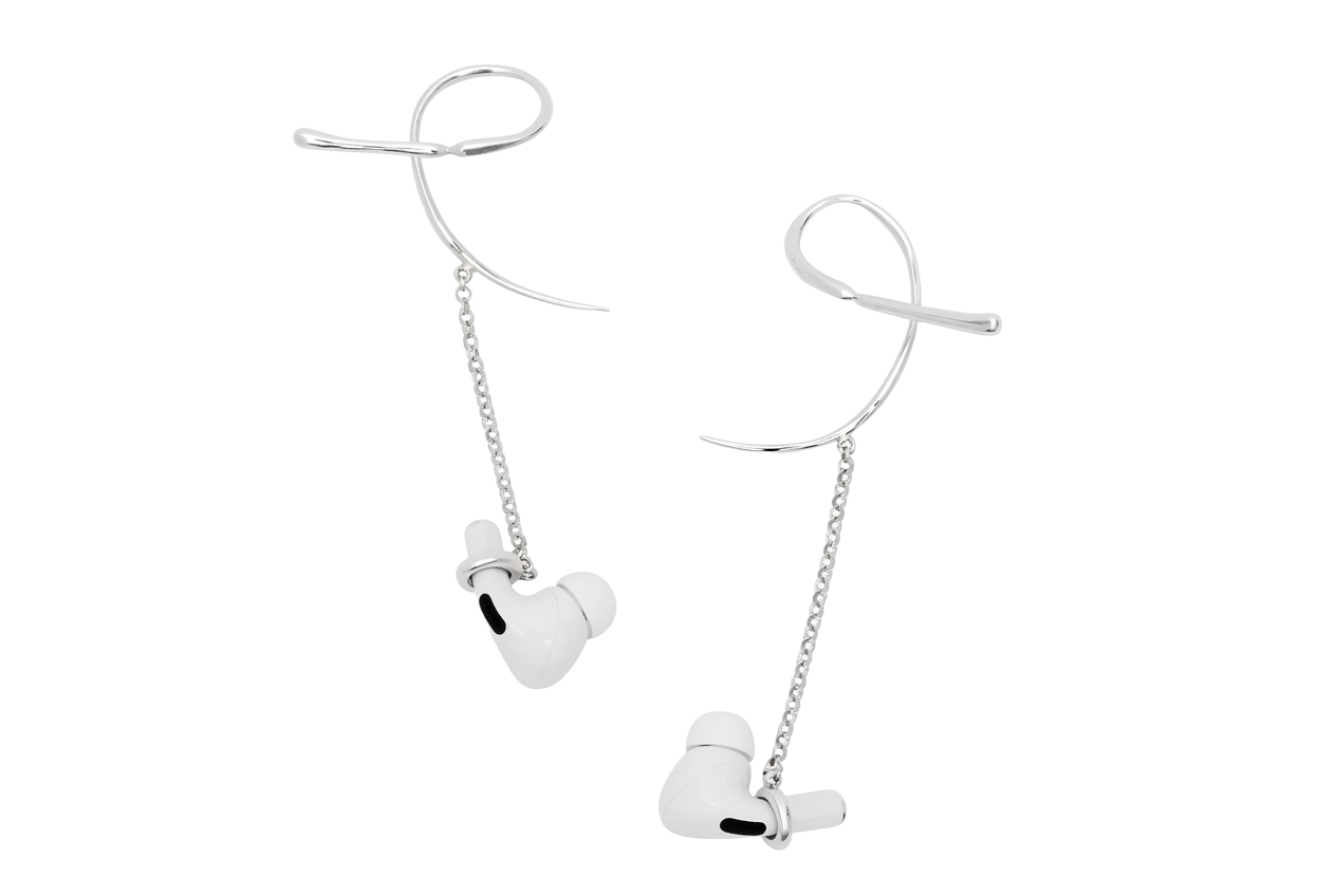 Echo Earcuffs shown holding a pair of white wireless earbuds