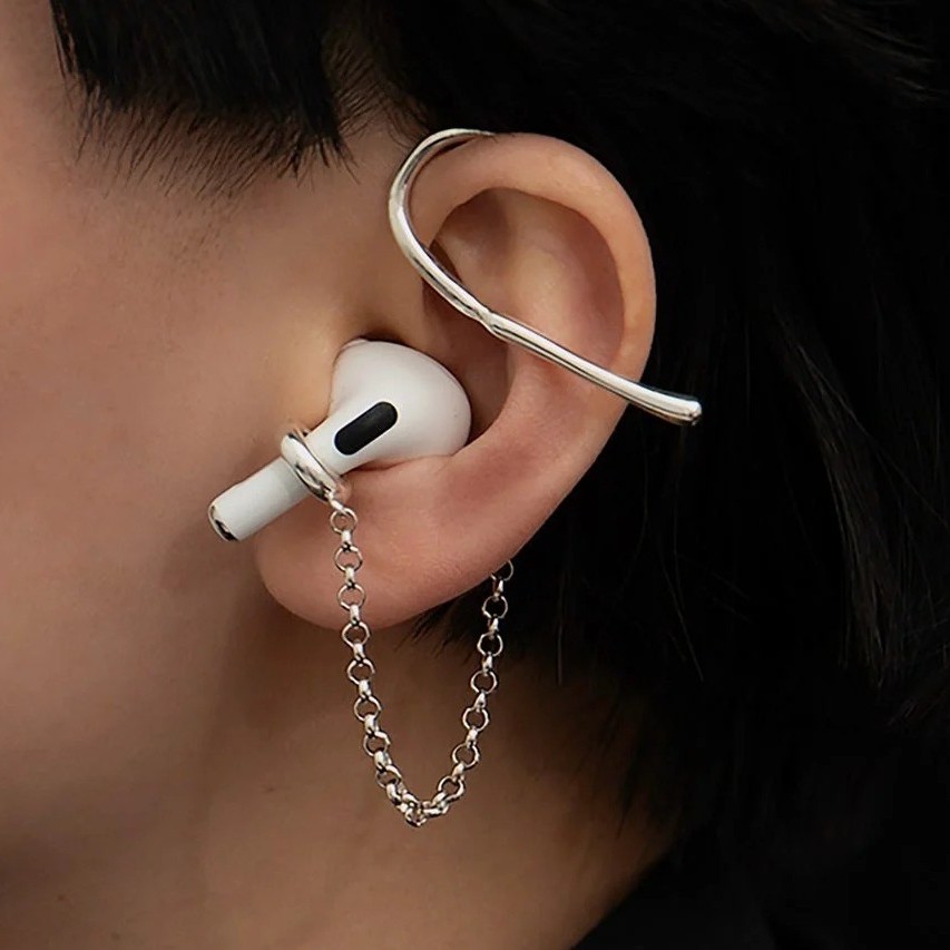 Close detail of the sterling silver cuff and chain securing an earbud